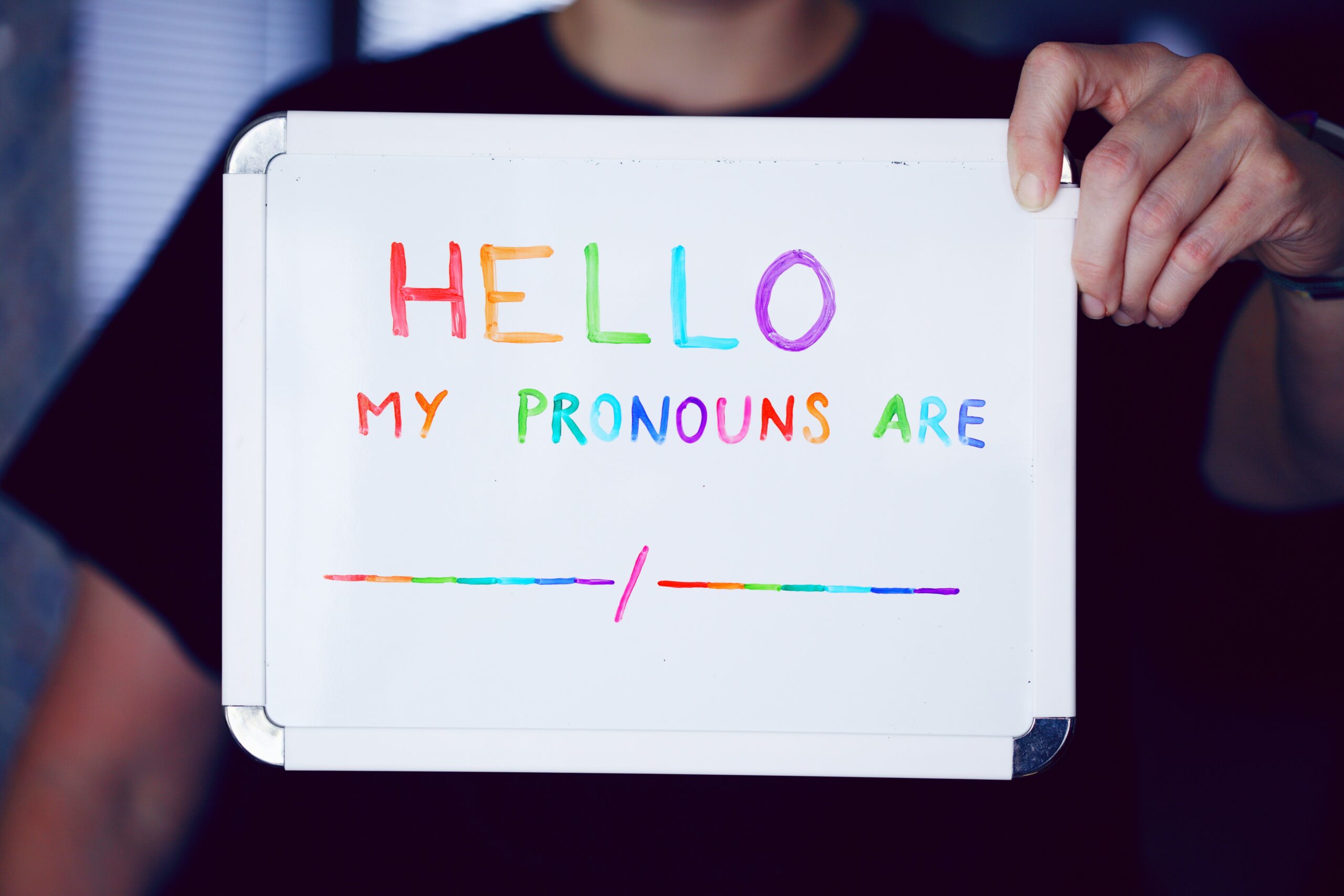 Sign reads, "Hello, my pronouns are..."